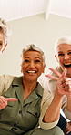 Face, hand gesture and happy with senior women in home together for bonding, fun or reunion. Emoji, peace sign and smile of old people in apartment for community, hangout or love as best friends