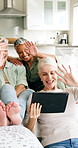 Tablet, video call and mature friends in home, waving and communication with funny contact online. Technology, virtual chat and women together in living room for greeting, laughing and conversation