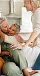 Hug, talking and visit with senior women on living room sofa for love, reaction or surprise. Bonding, conversation and excited with old friends embracing in home together for hangout or reunion