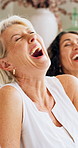Bonding, laugh or friends in home with chat, funny conversation or happy moment in reunion. Smile, gossip or mature women with group hangout, joke reaction or connection in healthy relationship.