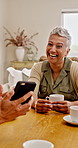Phone, laugh and mature friends in house for social media, conversation or online memory with drink. Mobile, group and women at home together to talk, share joke or show post on internet with coffee