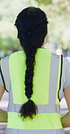 Safety, reflective or woman in park with vest, caution clothing or compliance in occupation protection. Back, workwear or person outdoor with ppe, hazard awareness or protocol gear in risk prevention