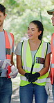 Volunteer, people and talk in park with safety vest, sustainability and planning for charity clean up. Happy, NGO team and discussion outdoor with PPE, recycling project or environmental conservation