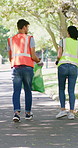 Volunteer, team and garbage bag in park with trash collection, charity project and waste management. People, cleaning outdoor and plastic for rubbish, sustainability and eco friendly NGO initiative.