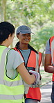 Volunteer, people and talk in park with gloves, sustainability and advice for NGO cleaning project. Team, discussion and charity leader outdoor with PPE, recycling plan or environmental conservation.