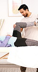 Physiotherapy, man and stretching knee for rehabilitation, recovery or joint injury for help. Physical therapy, healing support and muscle pain with person for healthcare, consultation or treatment