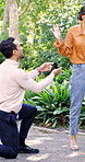 Woman, reject man and proposal in park, sad and disappointment with fail, mistake or regret. Couple, marriage offer and ring with stress, refuse and reaction with break up and relationship crisis