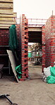 Outdoor, construction or empty brick wall on site for development progress, building or equipment. Masonry, residential structure or upgrade project for house extension, maintenance or roofing beams