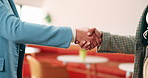 People, interview or business meeting with handshake in cafe for recruiting or onboarding agreement. Recruiter, employees or shaking hands with candidate in restaurant for hiring, teamwork or deal