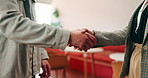 Business, interview and handshake with deal in cafe for recruiting or career onboarding agreement. People, recruiter or shaking hands with candidate in restaurant for hiring, teamwork or meeting