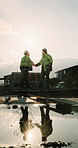 Construction, men and team with handshake on site for welcome, project collaboration or inspection. Space, building inspector or shaking hands outdoor for greeting, partnership or reflection on flare