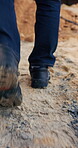Legs, walk and man on construction site for inspection, maintenance and renovation outdoor. Person, work boots and civil engineer for quality control, check building progress and property development