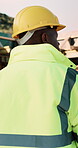 Thinking, helmet and back of black man on construction site with reflection, inspiration and planning. Architecture, contractor and person with ppe for safety compliance, building ideas or renovation