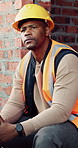 Contractor, man and eating at construction site with break, thinking or planning for renovation project. Black person, apple snack and rest outdoor with PPE, building infrastructure and manual labor.