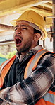 Tired, yawn and man by scaffolding at construction site, workload pressure and burnout for fatigue. Outdoor, overworked and worker with exhaustion for property development, building deadline or bored