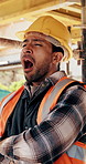 Break, tired and man with yawn at construction site, workload pressure and burnout for fatigue. Outdoor, overworked and worker with exhaustion for property development, building scaffolding or bored
