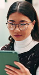 Reading, glasses or Asian woman with tablet in agency, editing draft or newsletter for email marketing. Review, eyewear or employee with tech to check mailing list, brand feedback or promotional ads