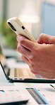 Hands, typing and laptop in office with phone notification, marketing analytics or check performance. Person, scroll or text message in business with computer, graphs or stats for advertising metrics