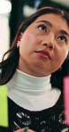 Woman, thinking and glass wall in office for planning, guest list and problem solving. Event planner, review and person with sticky note for vendor management, schedule or agenda for venue booking