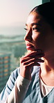 Nurse, woman and thinking in hospital with window, planning and problem solving for patient diagnosis. Healthcare worker, Asian person and vision in clinic with decision, perspective or medical idea.