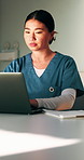 Administration, nurse and woman with laptop in clinic, typing and reading medical records on website. Healthcare, online and person with tech for test results, information or paperwork in hospital