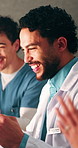 Excited, doctors or man with celebration in clinic for clear lab results, surgery approval or pride. Announcement, health team and fist pump for organ donor match, medical breakthrough and applause