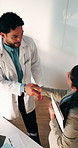Doctor, team and handshake in hospital with collaboration, manager advice or medical service approval. Above, clinic management and healthcare worker shaking hands with agreement, talking or support.