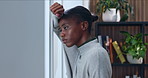 Black woman, anxiety and window in home for fear, overthinking or loss with pressure or phobia. Trauma, panic or female person with depression in living room with stress for mental health crisis