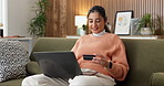 Woman, laptop or typing in living room with credit card, browsing website and payment for investment. Happy, person or fintech in home with computer, finance or eft transaction for wealth management.
