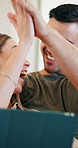 Excited, high five and couple with tablet, house and checking credit score on website in living room. People, kiss and celebration for milestone, achievement and happy for home loan approval on app