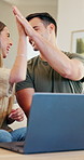 Laptop, high five and couple in home with planning anniversary holiday together with booking tickets. Conversation, talking and man with woman on computer for research on hotel checkin in apartment.