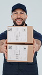 Boxes, happy and face of deliveryman in studio with confidence for distribution service. Smile, cardboard parcel and portrait of male logistics worker with packages for courier by white background.