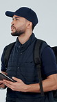 Navigation, tablet or delivery man with backpack in studio for direction on a white background. Male person, courier guy or walking with technology or app for package destination, address or location