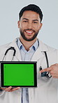 Face, tablet and doctor point with green screen, healthcare and insurance marketing in studio. Show tech, happy man or medical worker with mockup space, wellness or telehealth ads on white background