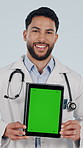 Face, tablet and doctor with green screen in studio, healthcare and insurance marketing. Tech display, happy man and medical worker with mockup space, wellness or telehealth ads on white background