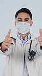 Doctor, thumbs up and man with face mask in studio, instruction and approval for medical protection. White background, safety and person with healthcare recommendation, wellness and health service