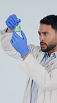 Science, studio and man with beaker for liquid, chemicals and research for medical analysis. Healthcare, chemistry and scientist with sample, experiment or medicine for vaccine on white background