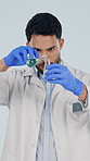 Beaker, pour and scientist in studio with liquid, vaccine or pharmaceutical experiment for lab study. Healthcare, medicine and man with sample, chemicals and medical research on white background