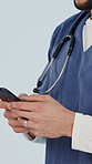 Hands, doctor and typing in studio with phone, research and contact patient for medical results. Man, reading or mobile for communication, agenda update and telehealth information on white background