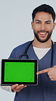 Doctor, face and man with tablet,  green screen and health website promotion and thumb up in studio. White background, medical specialist and happy person with tech, point and telehealth presentation