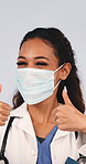 Doctor, thumbs up and woman with face mask in studio, instruction or approval for medical protection. White background, safety and person with healthcare recommendation, wellness and health services