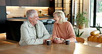 Coffee, phone and senior couple in home with laugh for funny meme on social media together. Cappuccino, happy and elderly man with woman on cellphone for reading blog on mobile app in apartment.