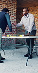 Team, blueprint and men in meeting for construction, renovation and planning for building design. Architecture, supervisor and people with layout, paperwork and discussion for remodeling project
