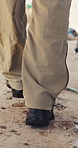 Walking, inspection and legs of man for construction site, quality assurance and building project. Architecture, contractor and back of worker for engineering, safety compliance and regulations