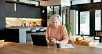 Typing, phone and internet with old woman in kitchen for social media, website info and app. Online taxes, retirement and senior person in home, tech for communication and message to contact or text