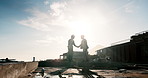 Construction, silhouette or men on site with handshake, greeting or deal in building project. Space, flare or engineers with shaking hands, partnership agreement or approval in industrial expansion.