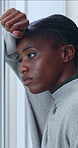 Thinking, depression and black woman by window in home with bad news, breakup or panic attack. Mental health, reflection and African female person with disappointment, frustration or overwhelmed.