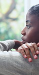 Window, depression and black woman in home with bad news, breakup or emotions in living room. Mental health, upset and African female person with disappointment, frustration or overwhelmed in house.
