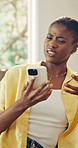 Phone, relax and black woman on sofa in home for texting, communication or social media on mobile app. Research, typing and female person with cellphone for chatting, networking or email in house.