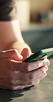 Man, hands and typing in home with phone, text message response or scroll for dating app notification. Person, browse and online chat in house with tech, internet connectivity or social media update.